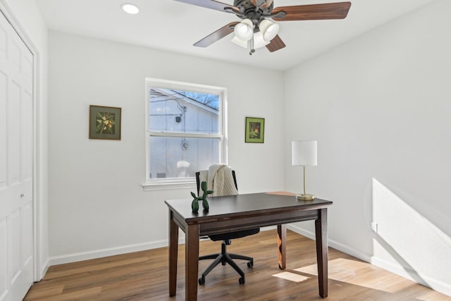 office space featuring wood-type flooring and ceiling fan