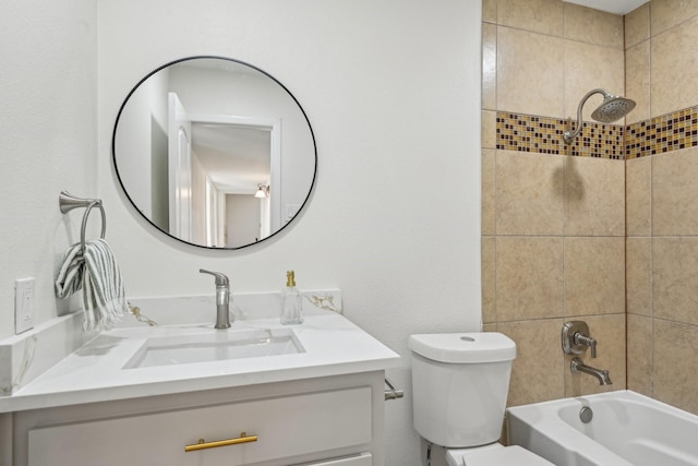 full bathroom with toilet, vanity, and tiled shower / bath