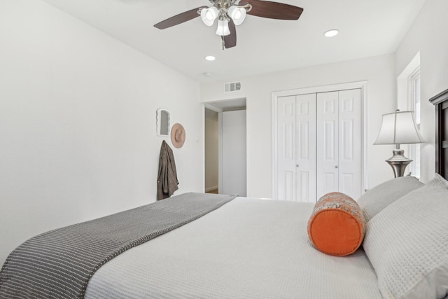 bedroom with ceiling fan and a closet