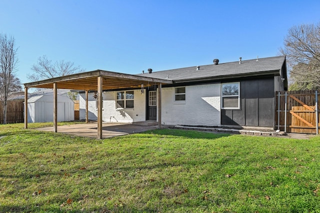 back of house with a storage unit, a yard, and a patio