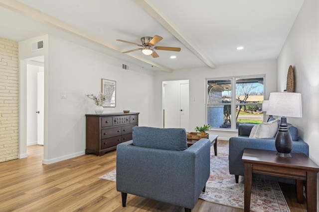 living room with beamed ceiling, ceiling fan, and light hardwood / wood-style floors