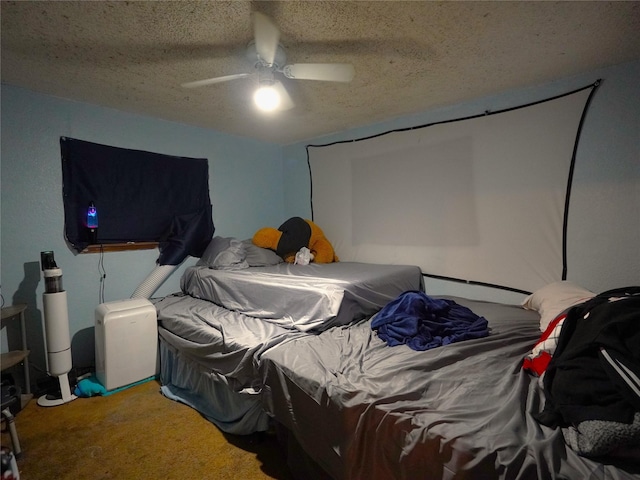 carpeted bedroom featuring ceiling fan and a textured ceiling