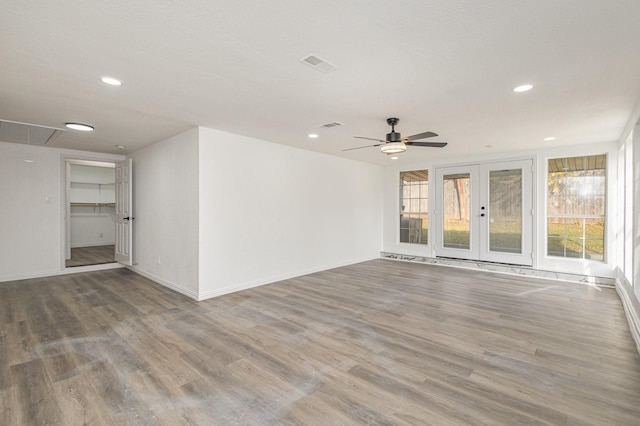 unfurnished room with ceiling fan, french doors, and hardwood / wood-style flooring