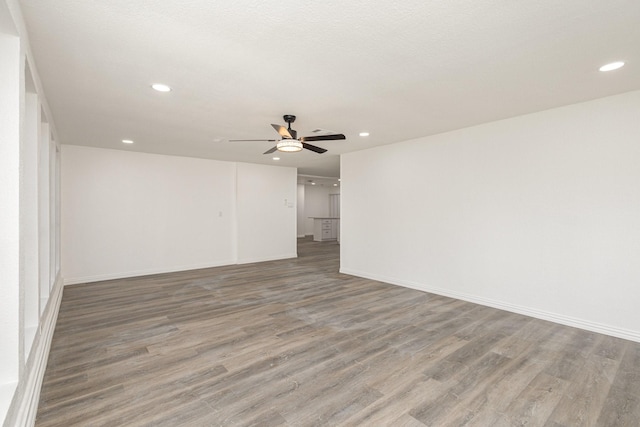 unfurnished room with wood-type flooring and ceiling fan