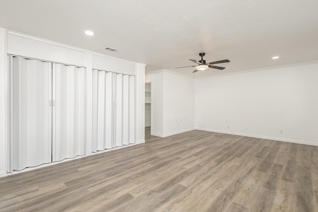 empty room with hardwood / wood-style floors, ceiling fan, and ornamental molding