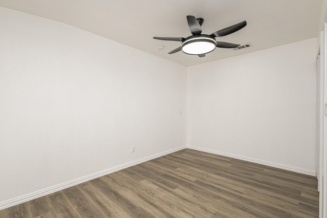 unfurnished room with dark hardwood / wood-style floors and ceiling fan