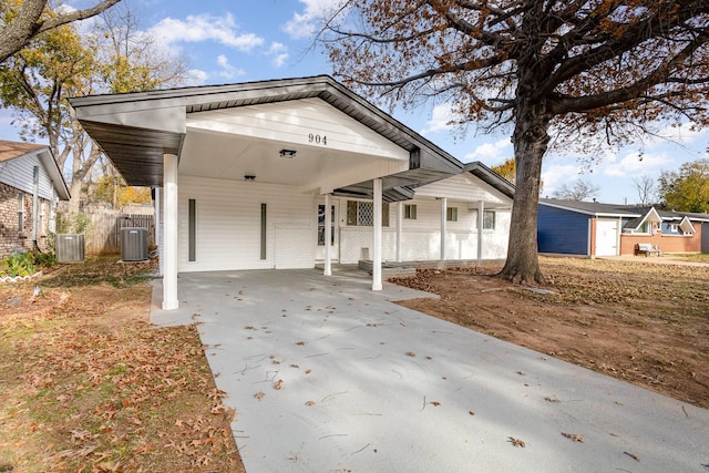 view of front of home with a carport and cooling unit