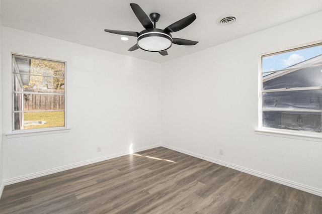 spare room with ceiling fan and dark wood-type flooring