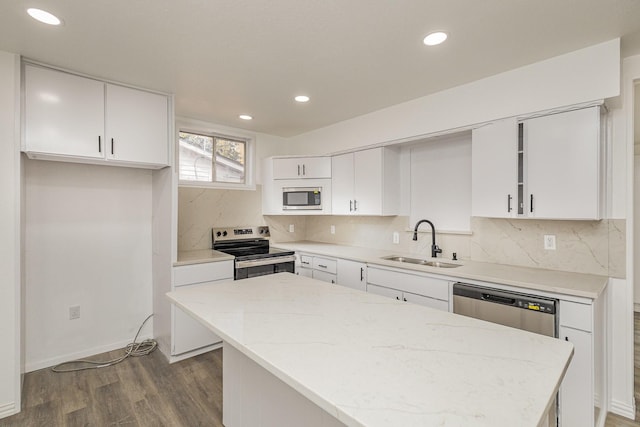 kitchen featuring a center island, sink, stainless steel appliances, dark hardwood / wood-style flooring, and white cabinets