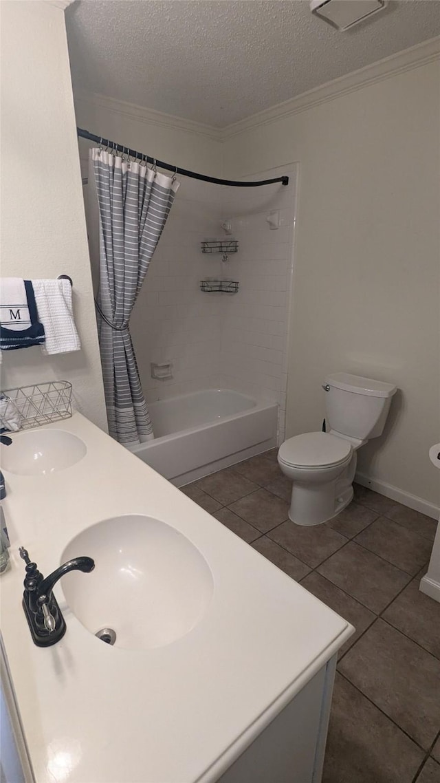 full bathroom with tile patterned flooring, a textured ceiling, shower / bathtub combination with curtain, and sink