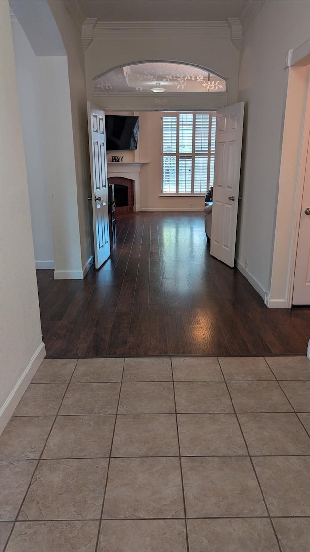 corridor with wood-type flooring and ornamental molding