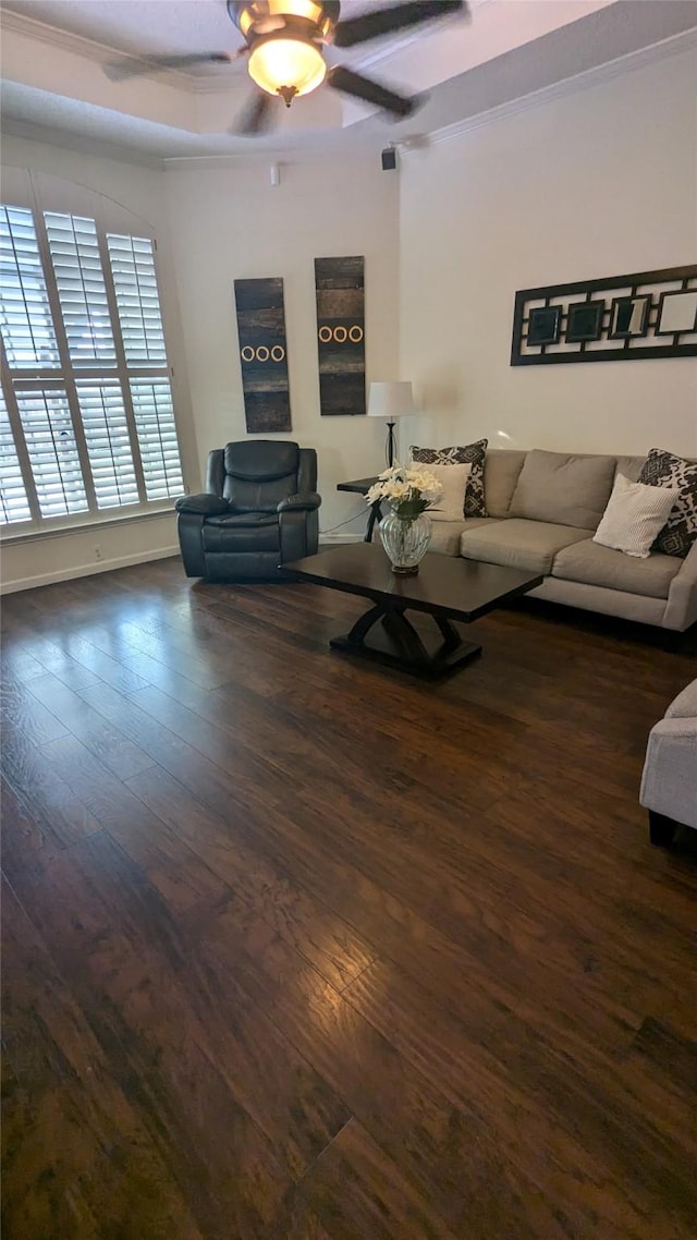 living room featuring ceiling fan, dark hardwood / wood-style flooring, and ornamental molding