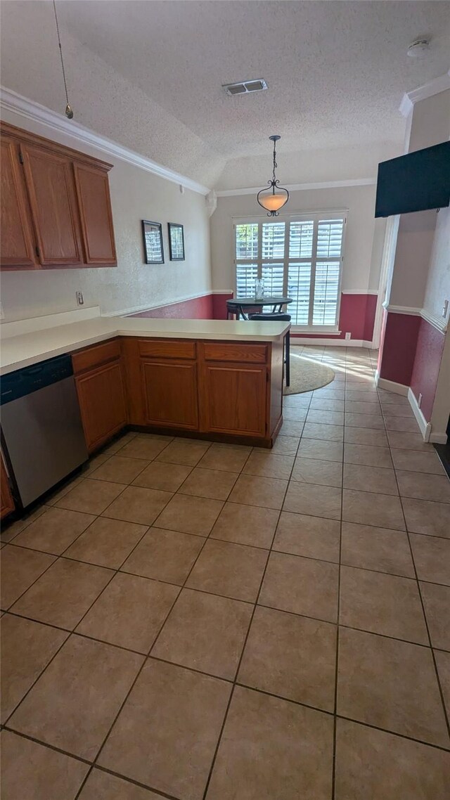 kitchen featuring dishwasher, hanging light fixtures, a textured ceiling, light tile patterned floors, and ornamental molding