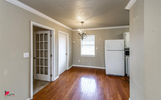 kitchen with white appliances, sink, light hardwood / wood-style flooring, ornamental molding, and white cabinetry