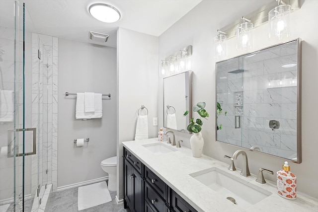 bathroom with vanity, toilet, and a shower with shower door