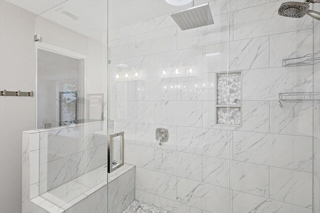 bathroom featuring a shower with shower door