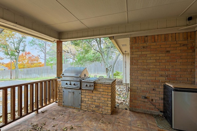 view of patio / terrace featuring a grill and an outdoor kitchen