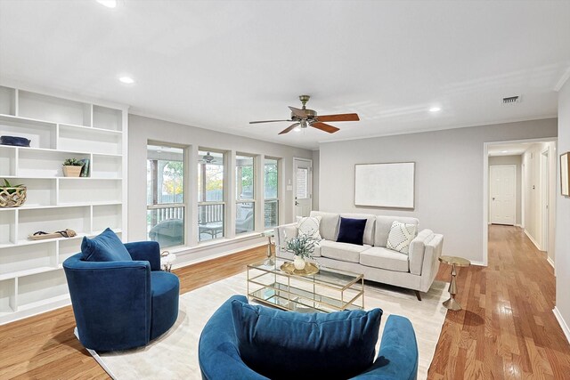 living room with ceiling fan and light hardwood / wood-style floors