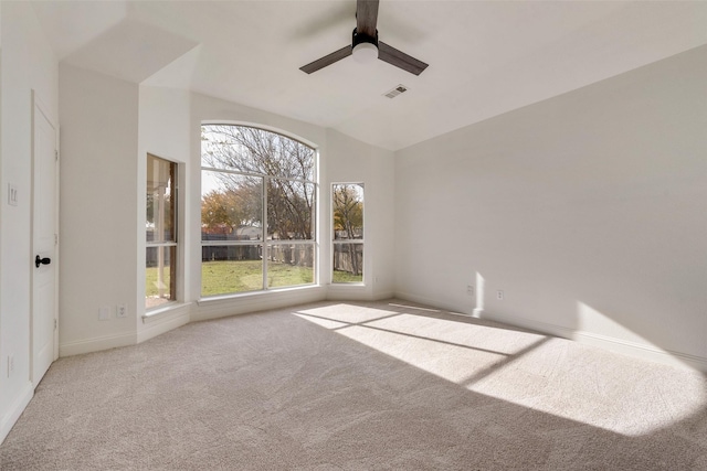 unfurnished room with light carpet, lofted ceiling, and ceiling fan