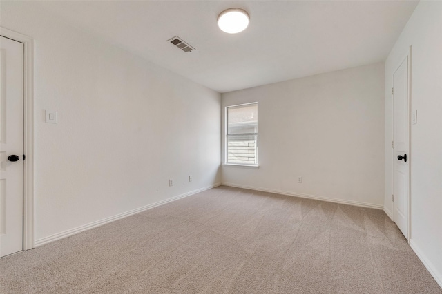 unfurnished room with light colored carpet