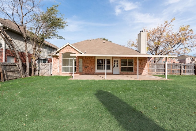 rear view of house featuring a patio and a lawn