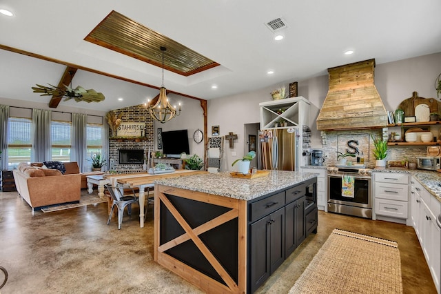 kitchen featuring appliances with stainless steel finishes, backsplash, custom range hood, pendant lighting, and white cabinetry