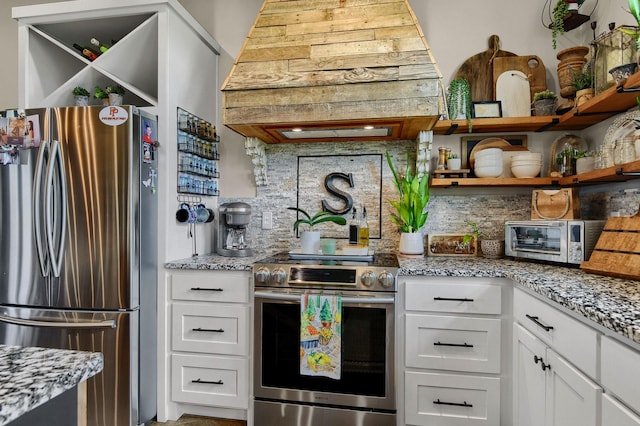 kitchen featuring white cabinets, decorative backsplash, and appliances with stainless steel finishes