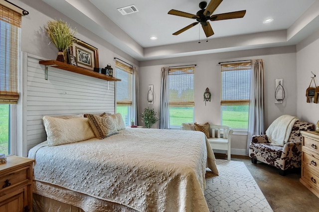 bedroom with ceiling fan and multiple windows