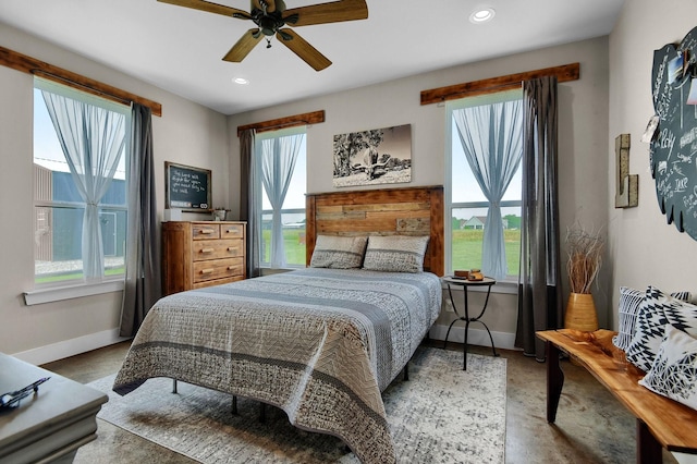 bedroom with ceiling fan and multiple windows