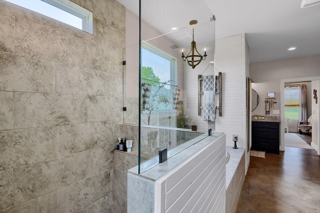 bathroom featuring plenty of natural light, concrete flooring, and tiled shower