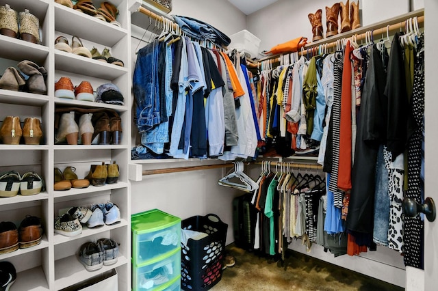 spacious closet with dark carpet