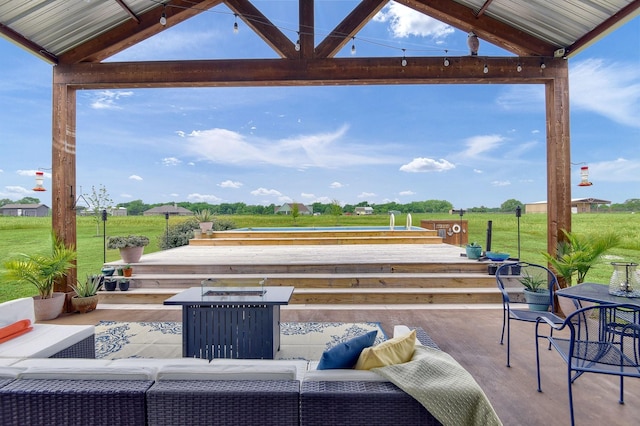 view of patio / terrace with an outdoor living space with a fire pit