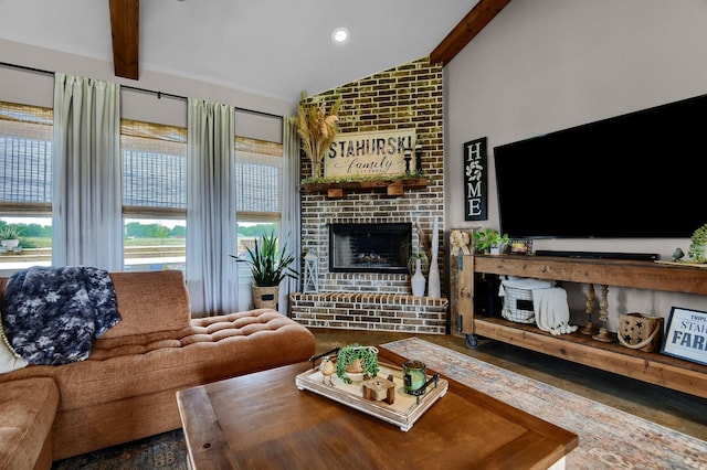 living room featuring lofted ceiling with beams and a brick fireplace