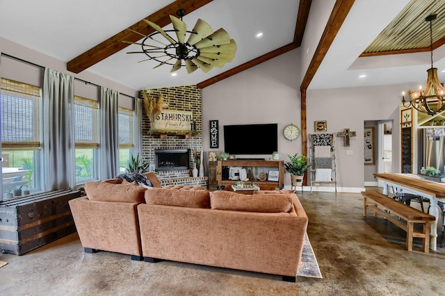 living room with a wealth of natural light, beamed ceiling, and concrete floors