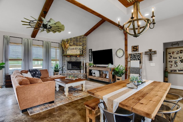 living room with high vaulted ceiling, ceiling fan with notable chandelier, a brick fireplace, beam ceiling, and concrete flooring