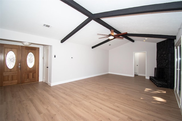 unfurnished living room featuring lofted ceiling with beams, ceiling fan, a fireplace, and light hardwood / wood-style floors