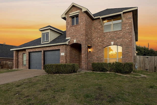 front facade featuring a yard and a garage