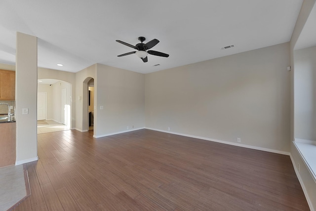 unfurnished room featuring ceiling fan and dark hardwood / wood-style flooring