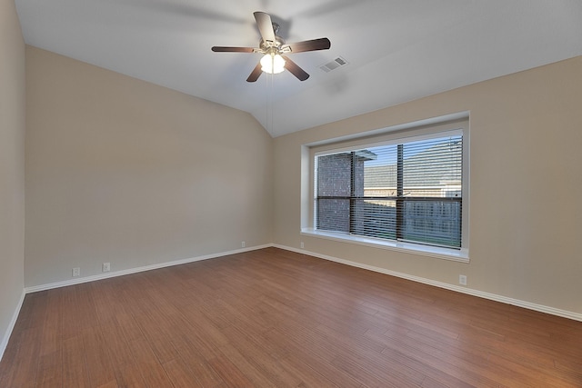 unfurnished room featuring hardwood / wood-style flooring, vaulted ceiling, and ceiling fan