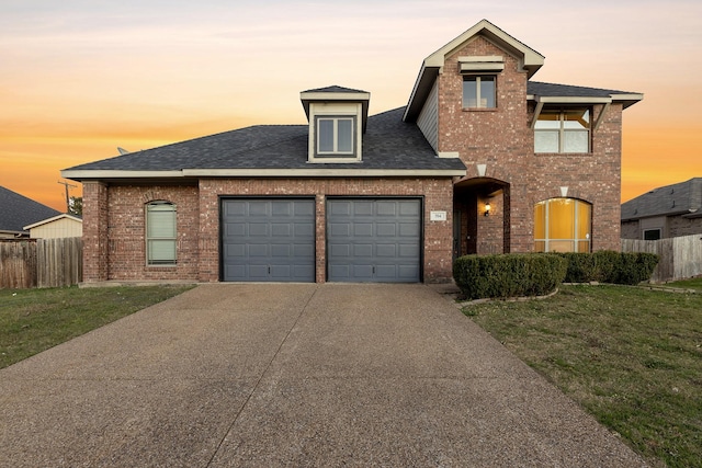 view of front facade featuring a lawn and a garage