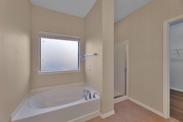 bathroom featuring tile patterned floors and plus walk in shower