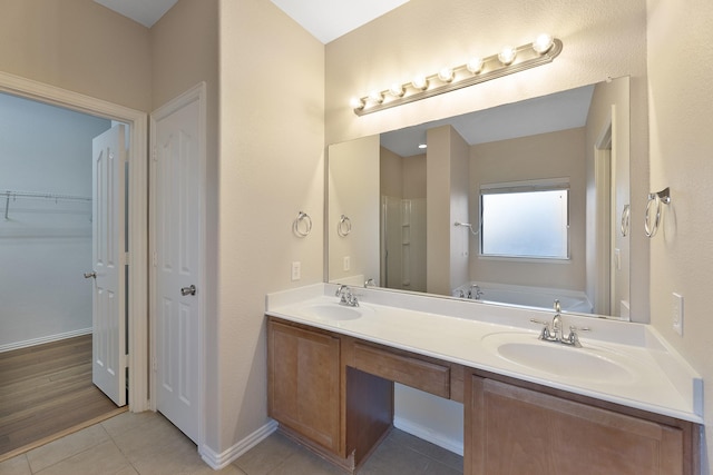 bathroom with hardwood / wood-style floors, vanity, and shower with separate bathtub