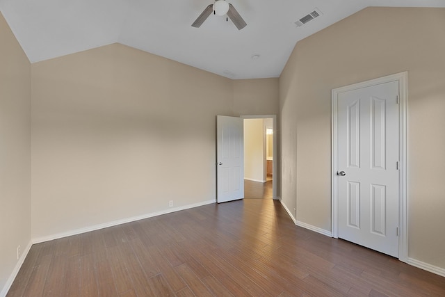 unfurnished bedroom with lofted ceiling, ceiling fan, and dark hardwood / wood-style floors