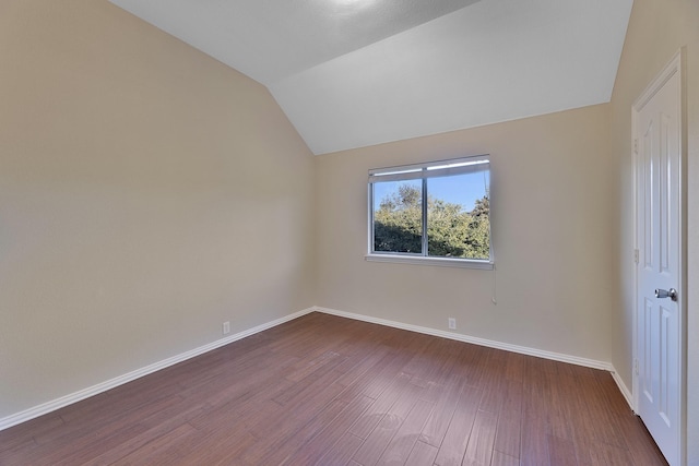 unfurnished room featuring wood-type flooring and lofted ceiling