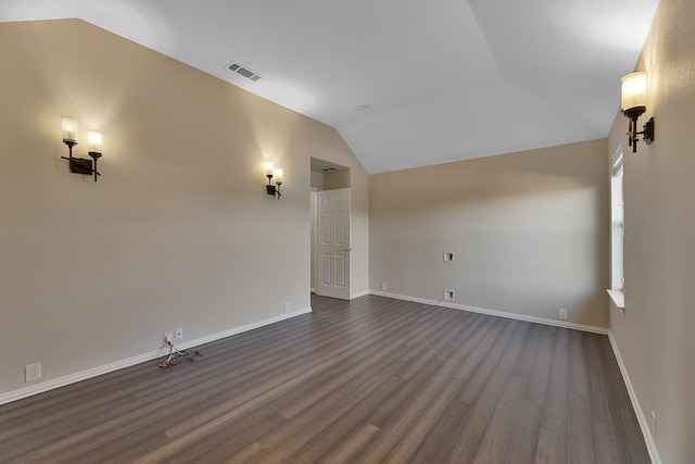 interior space featuring lofted ceiling and dark hardwood / wood-style floors