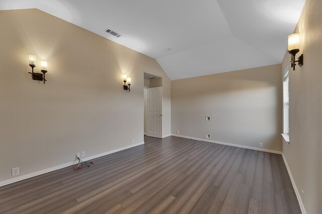 interior space featuring lofted ceiling and dark hardwood / wood-style floors