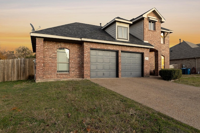 view of front of home featuring a lawn and a garage