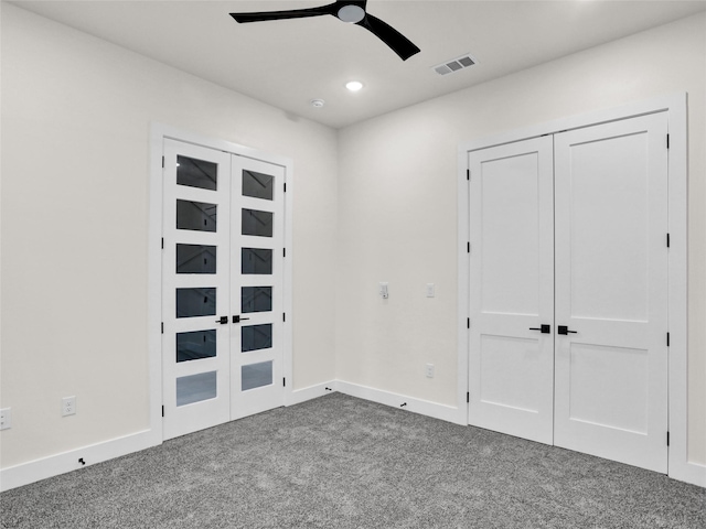 unfurnished bedroom with carpet, french doors, a closet, and ceiling fan