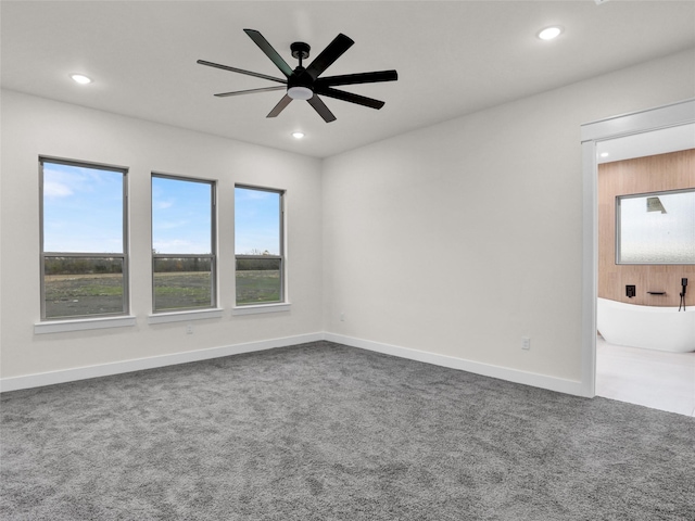 carpeted empty room featuring ceiling fan