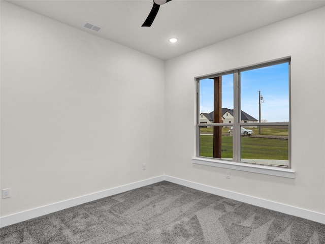 carpeted empty room featuring ceiling fan